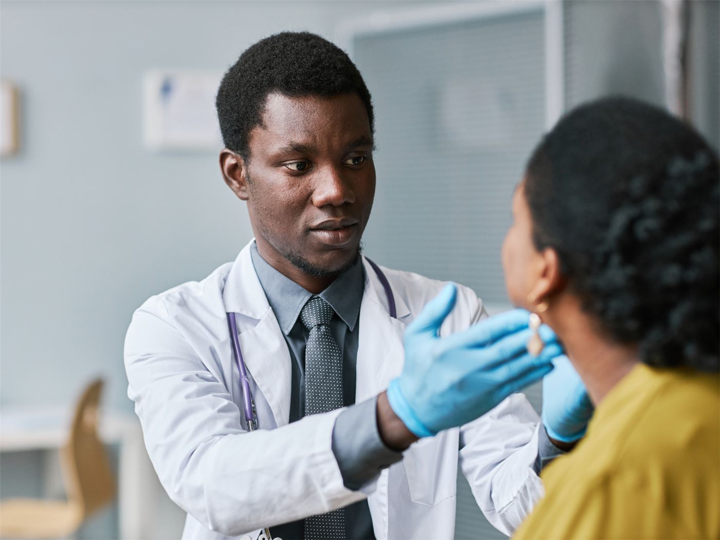 A clinician examining a patient during a consultation