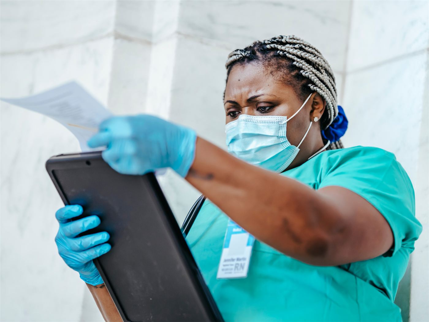 A nurse reviewing paperwork on a ward
